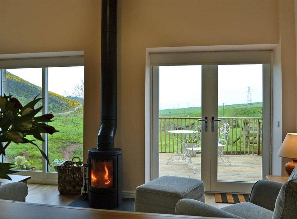 Cosy living area with wood burner and superb views at Bridge Cottage, 
