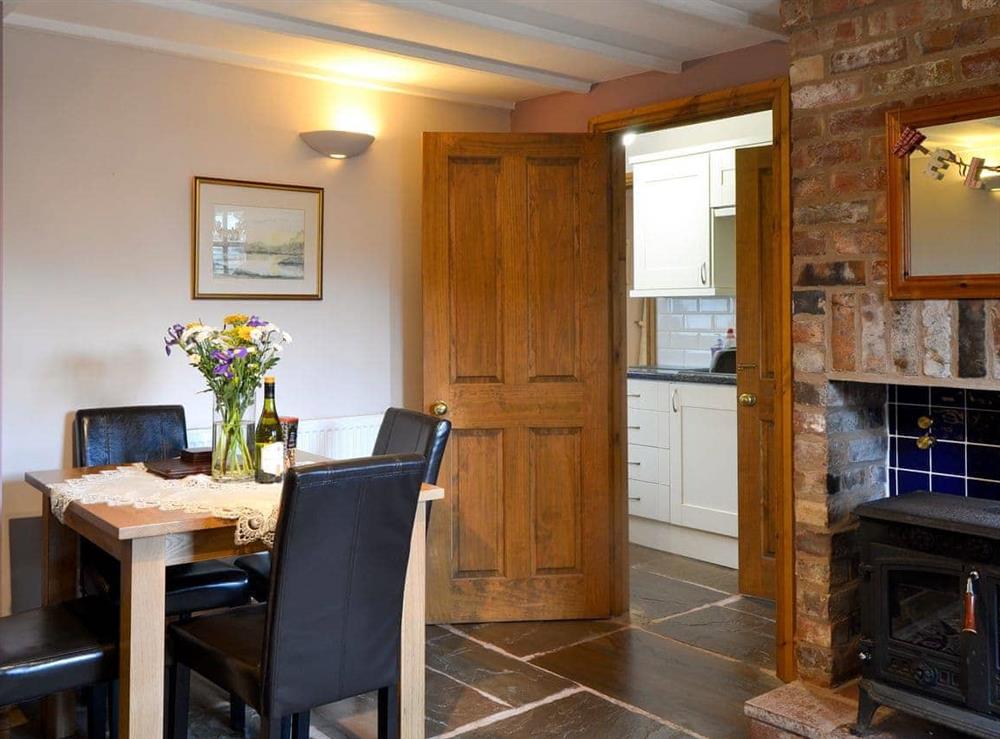The cosy woodburner and stone floors complement the exposed brickwork of the fireplace at The Barn, 