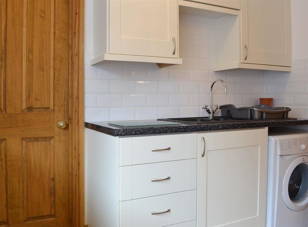 The kitchen also has a utility area with laundry facilities at The Barn, 