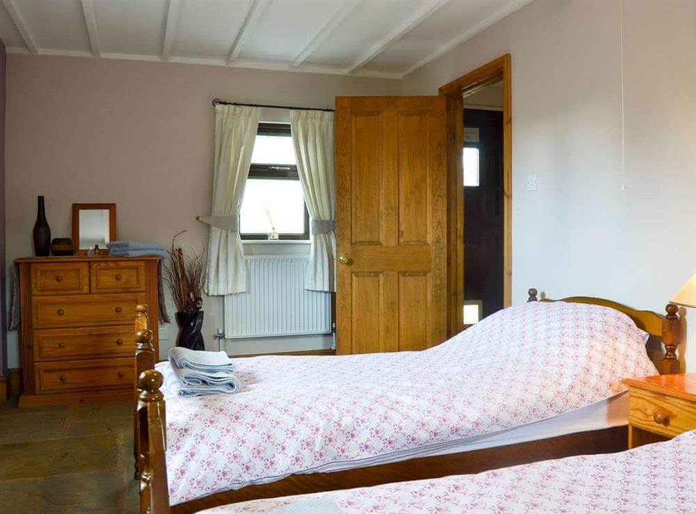 The romantic, shabby chic double bed is cosy and comfortable at The Barn, 