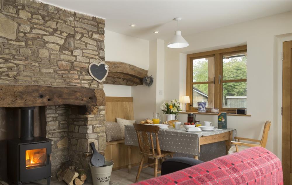 Enjoy the warmth of the fire from the dining alcove at New Inn Cottage, Cardington