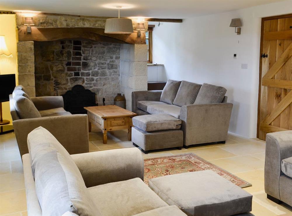 Large living room with wood burner at New Inn Farmhouse in Marnhull, near Shaftesbury, Dorset