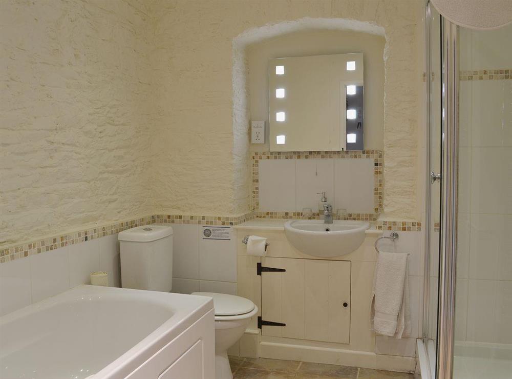 The family bathroom has a shower attachment and a full-height walk-in shower at Badgers Holt, 