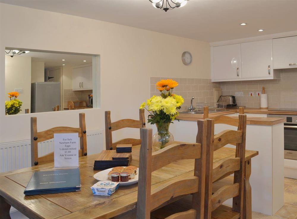 The large dining table is adjacent to the kitchen at Badgers Holt, 