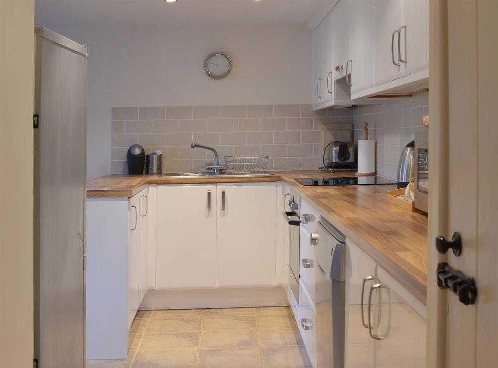 The well-equipped kitchen has a tiled floor at Badgers Holt, 
