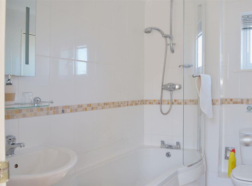 The first floor bathroom has a shower over the bath and a wc at Dartmoor View, 