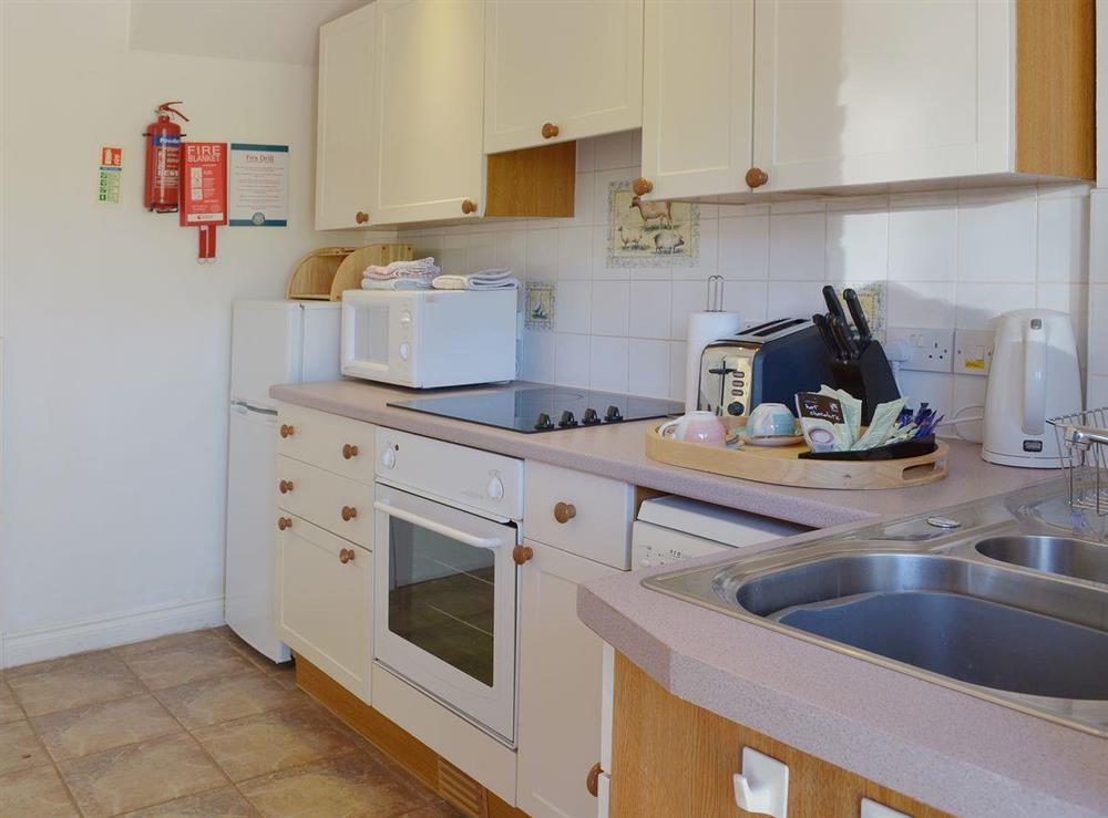 The well-equipped kitchen area is furnished in a modern yet traditional style at Lambs Gate, 