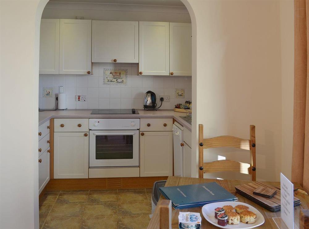 The kitchen area is just a few short steps from the dining area at Oak Tree Cottage, 