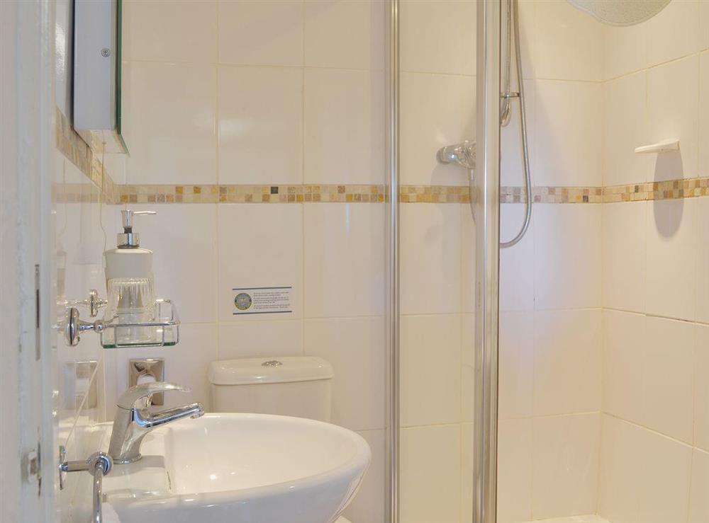 The fully-tiled shower room has a three-piece suite including a walk-in shower at Pheasants Hide, 