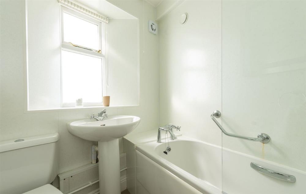 Bathroom with bath and shower over at Nimbus Cottage, Trevose Head Lighthouse