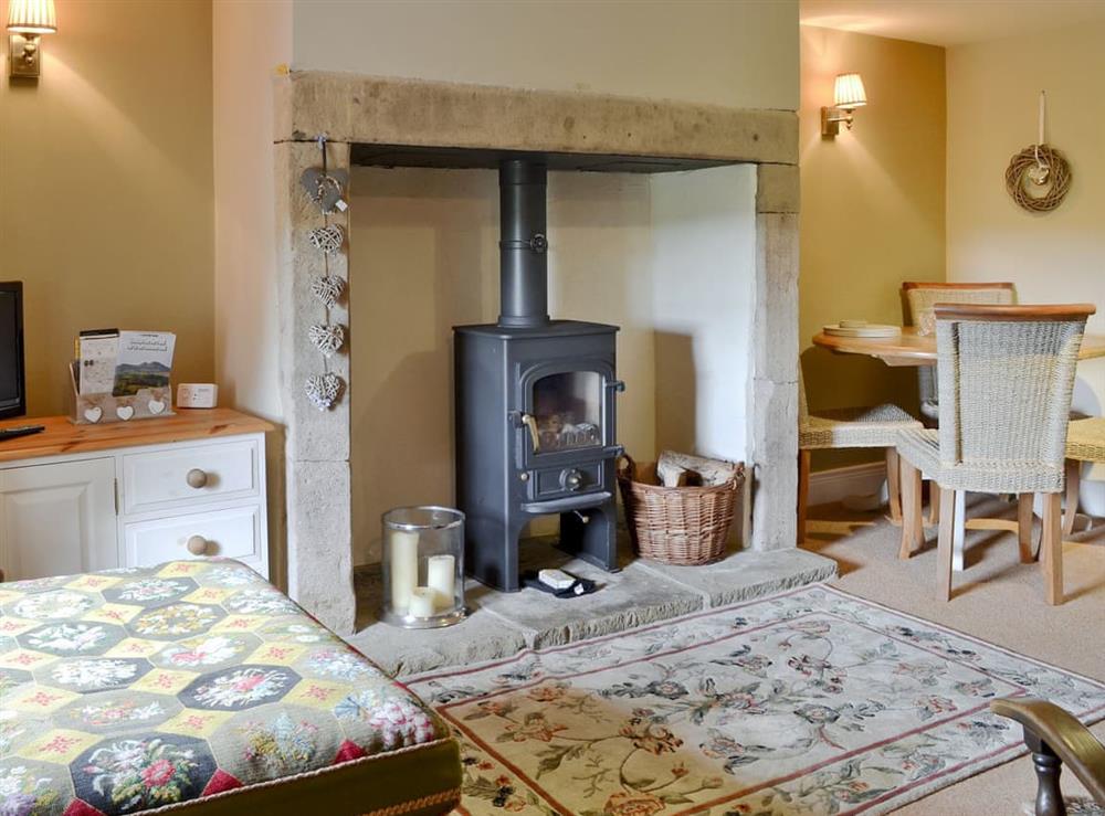 Cosy living/ dining room with wood burner at No 2 Cottage in Hexham, Northumberland