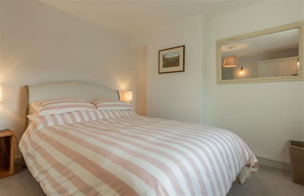 First floor: Bedroom two with king-size bed at No. 3 Sutherland Cottages, Brancaster near Kings Lynn