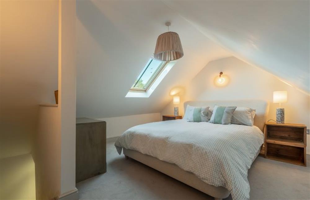 Second floor: Master bedroom with king-size bed at No. 3 Sutherland Cottages, Brancaster near Kings Lynn