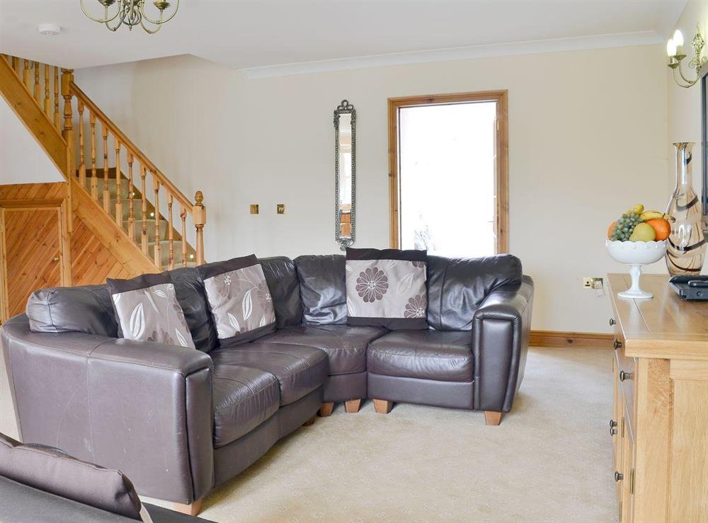 Living room area with corner sofa at No 4 Pengraig Draw in Aberystwyth, Dyfed