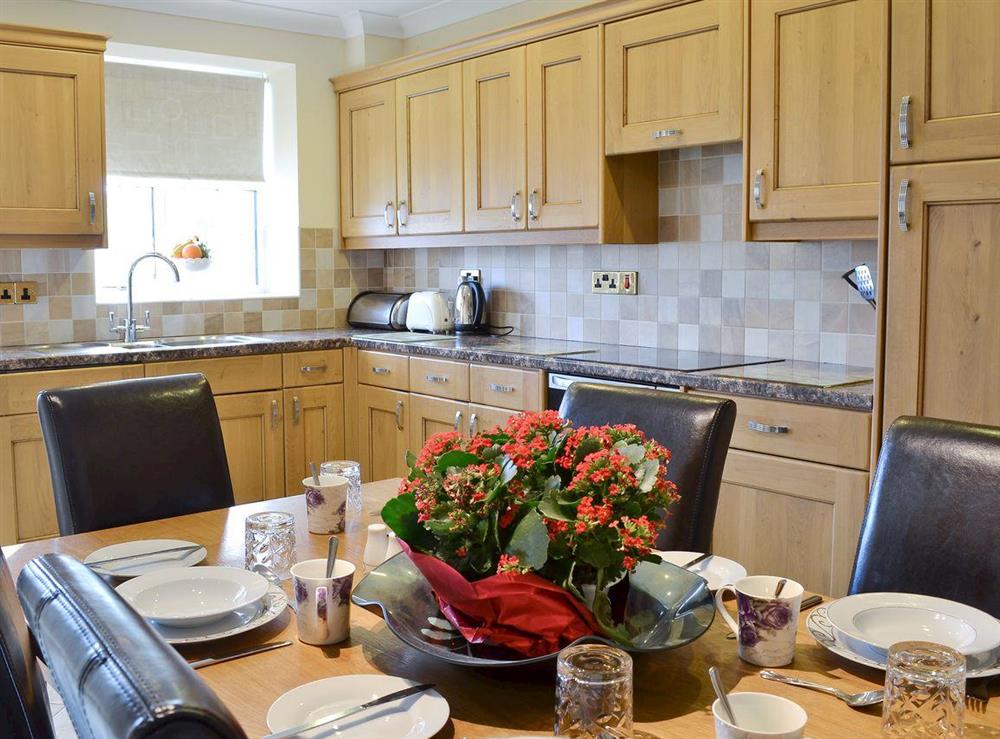 Well equipped kitchen with dining area at No 5 Pengraig Draw in Aberystwyth, Dyfed