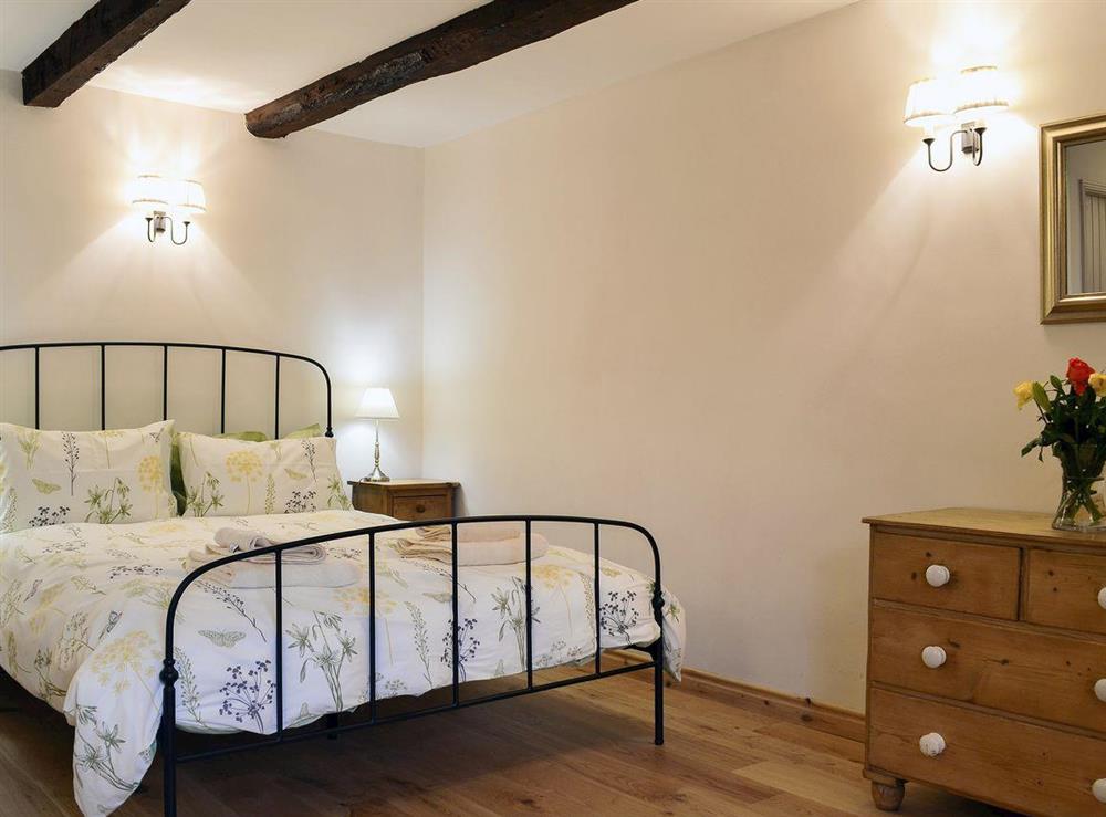 Spacious double bedroom with beamed ceiling at No 6 Swallowholm Cottages in Arkengarthdale, North Yorkshire