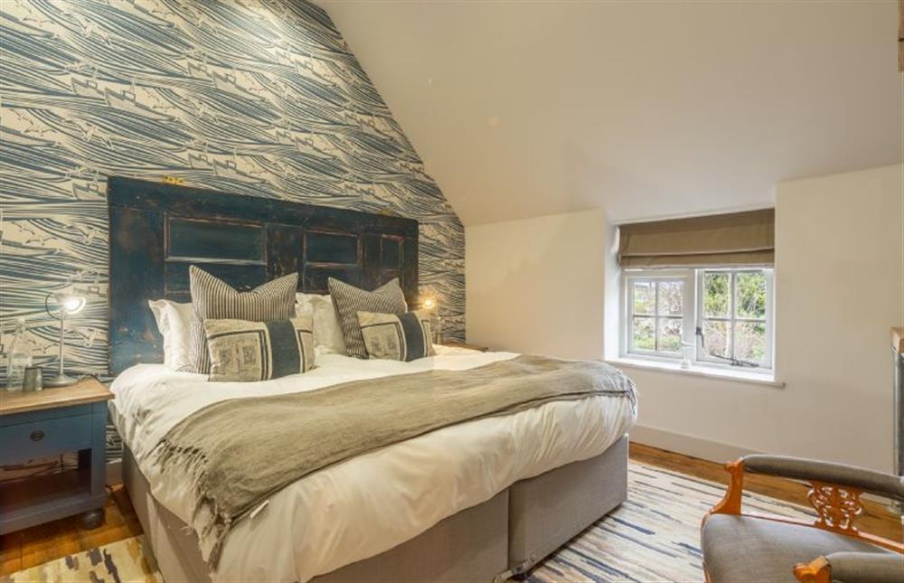 First floor: Master bedroom has super-king size bed at No.33 Cottage 4, Thornham near Hunstanton