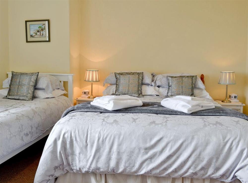 Double bedroom with additional single bed at Noddfa in Harlech, Gwynedd., Great Britain
