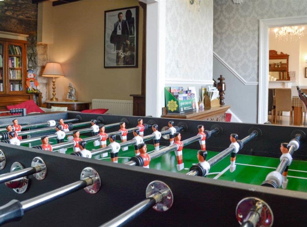 Entertaining table football game within the entrance hall at Noddfa in Harlech, Gwynedd., Great Britain