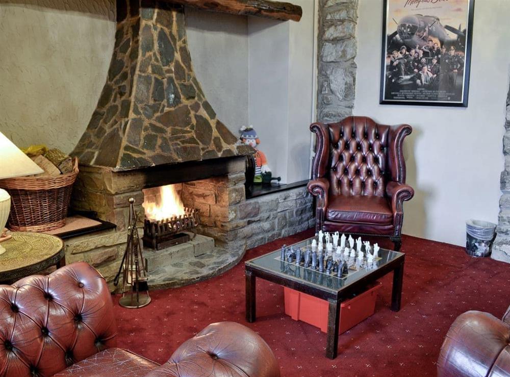 Living room with open fire at Noddfa in Harlech, Gwynedd., Great Britain