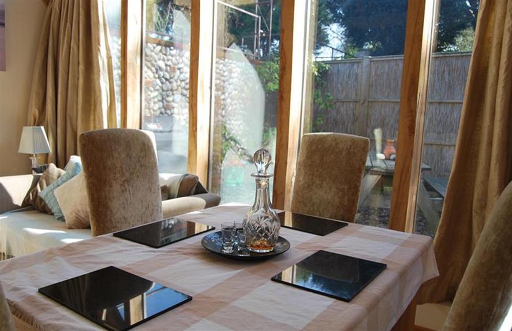 Ground floor:  Dining area with table with seating for four at Nooky House, Cley-next-the-Sea near Holt