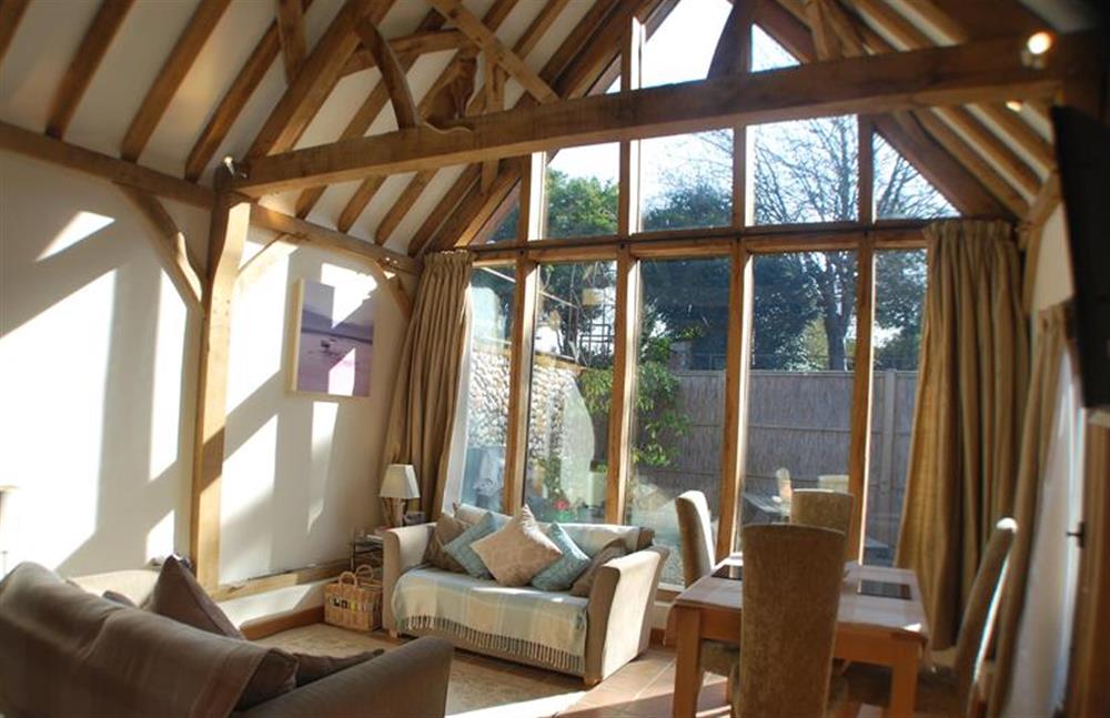 Ground floor:  Sitting/dining area with feature beams and glazed gable end at Nooky House, Cley-next-the-Sea near Holt
