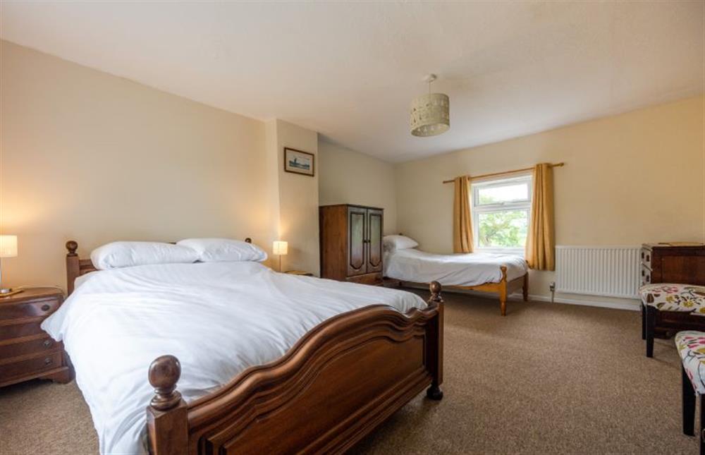 First floor: Master bedroom with a double bed, and further single bed at Norahs Cottage, Potter Heigham near Great Yarmouth