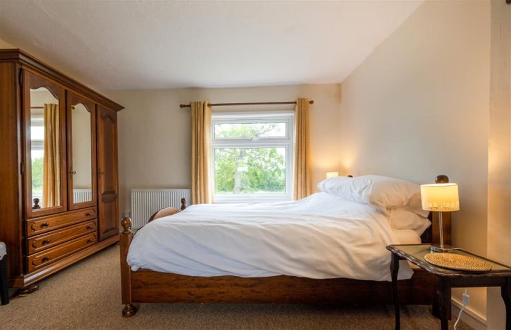 First floor: Master bedroom with a double bed at Norahs Cottage, Potter Heigham near Great Yarmouth