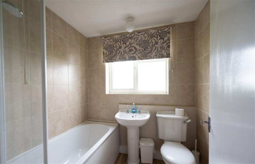 Ground floor: Bathroom with a bath and shower over, wash basin and WC at Norahs Cottage, Potter Heigham near Great Yarmouth