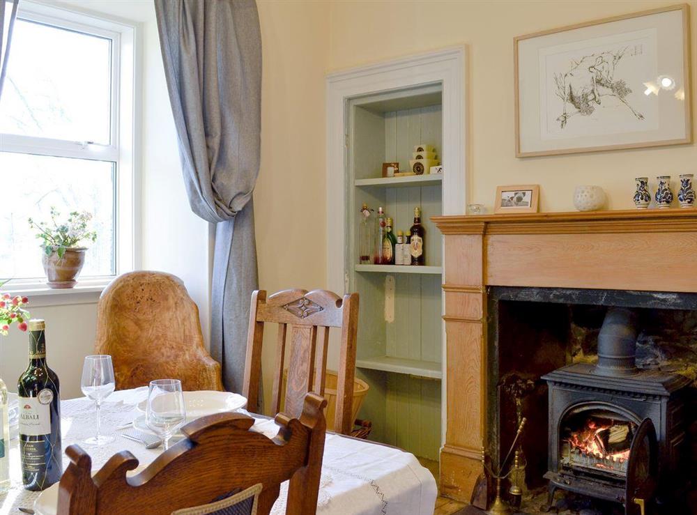 Dining room with wood burner at North Balloch Farmhouse in Barr, near Girvan, Ayrshire