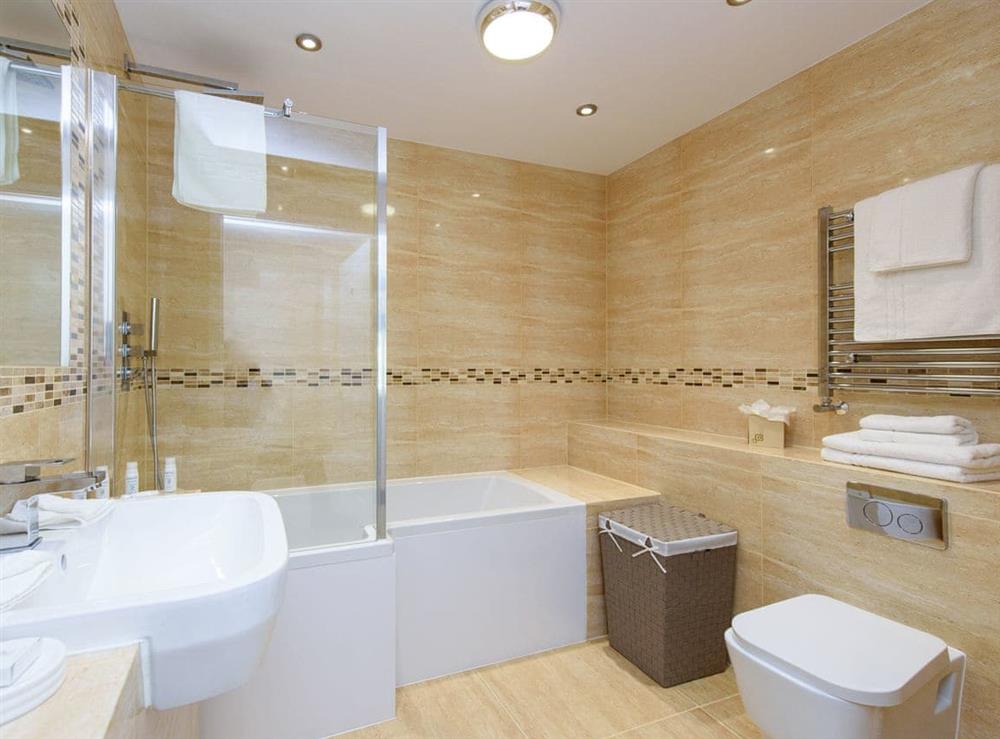 Family bathroom with shower over bath at North Bay Sands Apartment 3 in Scarborough, North Yorkshire
