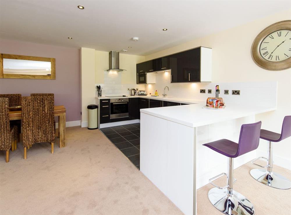 Kitchen area with breakfast bar at North Bay Sands Apartment 3 in Scarborough, North Yorkshire
