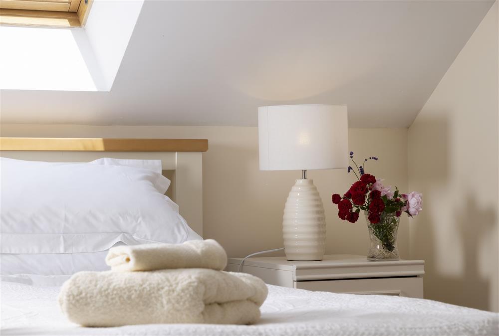 First floor: Bedroom one with 6ft super-king size bed with Velux window above the bed at North Leigh Barn, Crediton