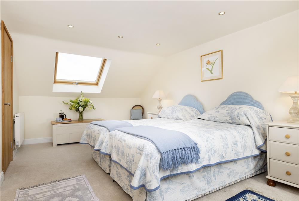 First floor: Bedroom two with twin 3ft single beds and en-suite shower room at North Leigh Barn, Crediton