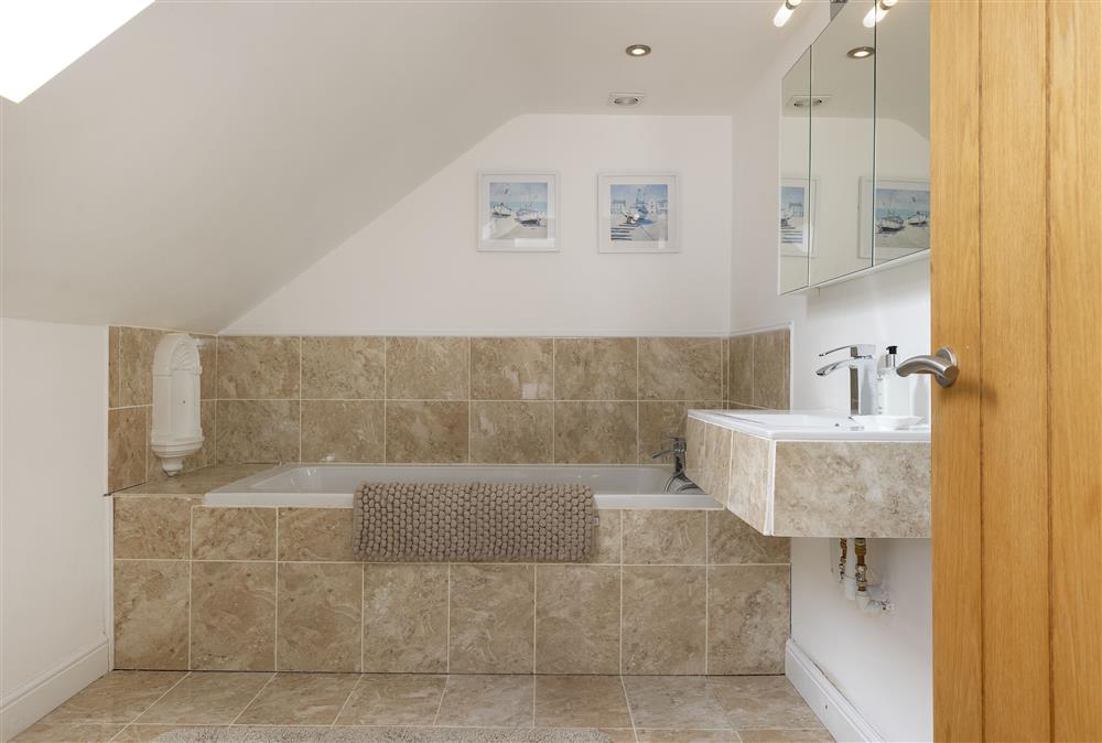 First floor: En-suite to bedroom one with bath and hand-held shower attachment  at North Leigh Barn, Crediton 