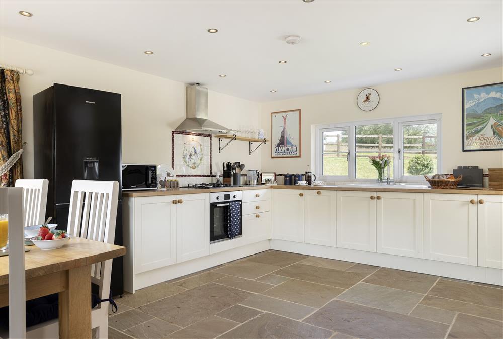 Ground floor: Open-plan kitchen/dining area with Sonos speaker at North Leigh Barn, Crediton 