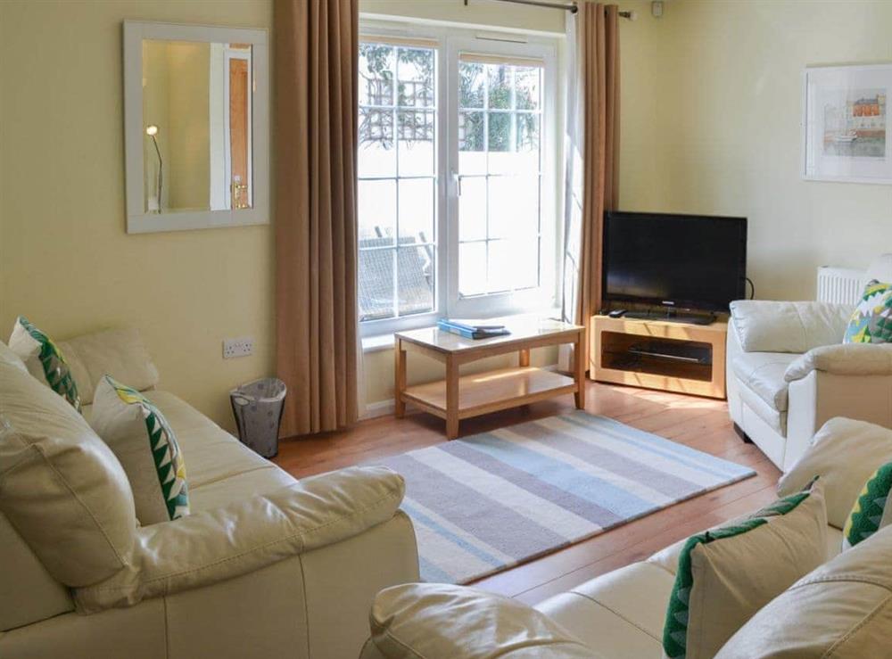 Lovely living room with French doors to the garden at North Shore in Crantock, N. Cornwall., Great Britain