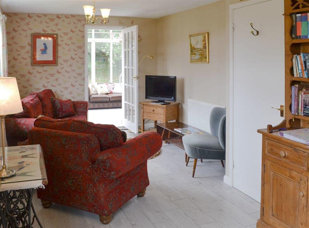 Comfortable living room at Northcombe Bungalow in Beaworthy, Devon