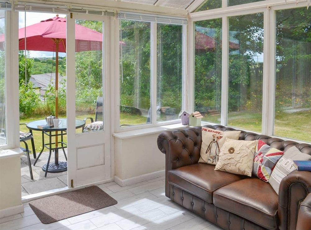 Conservatory leading into the garden at Northcombe Bungalow in Beaworthy, Devon