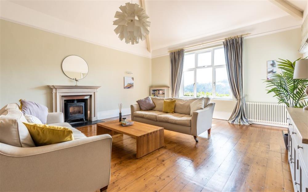 Elegant sitting room with high ceilings, exposed oak flooring and feature log burner. at Number 1, Thurlestone Court in Dartmouth