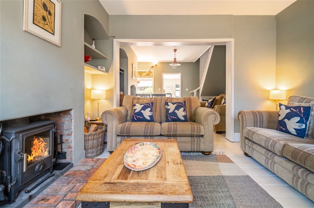 Cosy open-plan living area with a wood burning stove at Number 22, Aldeburgh