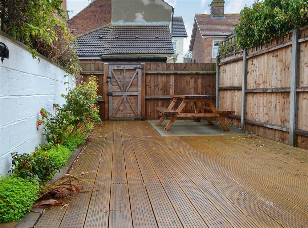 Enclosed courtyard garden with decking and garden furniture (photo 2) at Number 8 in Sheringham, Norfolk