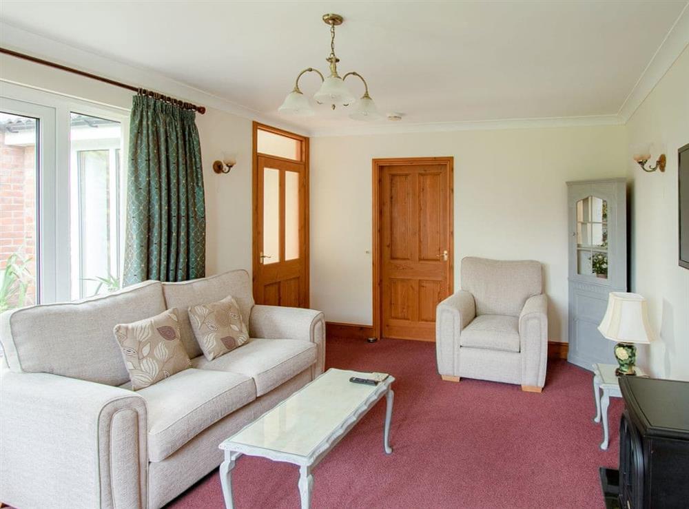 Airy lounge with French doors to rear patio at Nursery Cottage in North Somercotes, near Louth, Lincolnshire