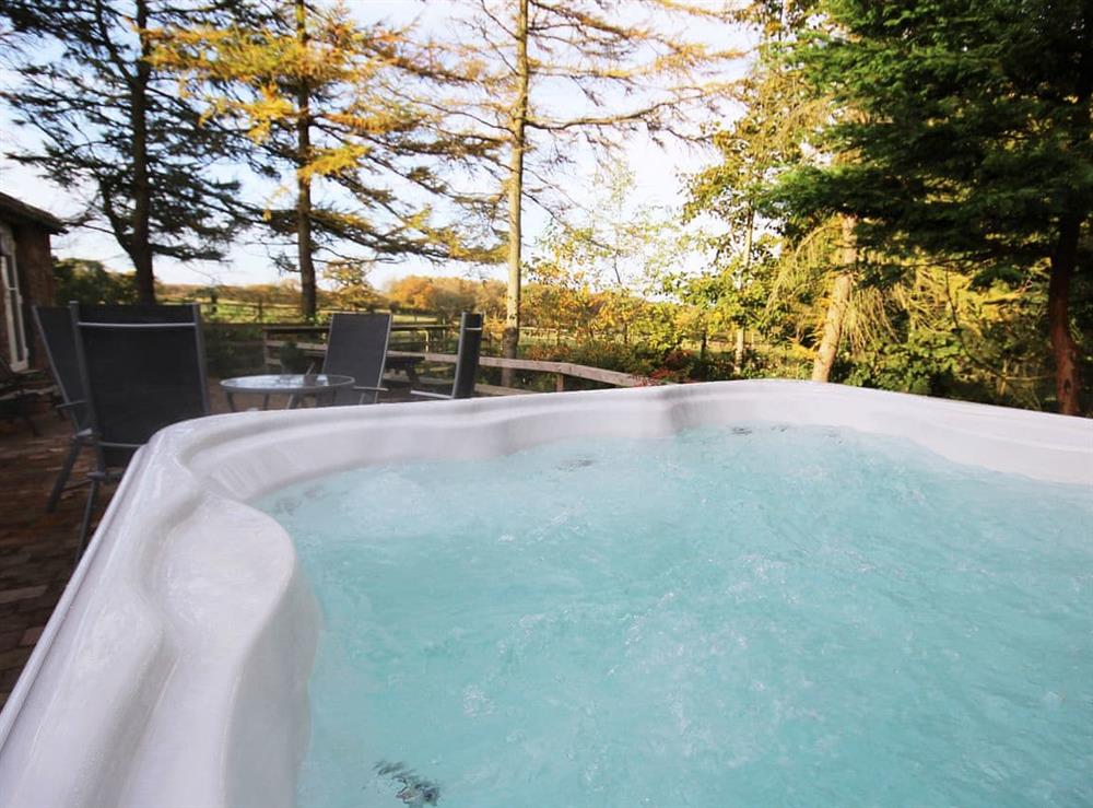 Relax in the private Jacuzzi hot tub at Nuthatch Cottage in Wigton, Cumbria