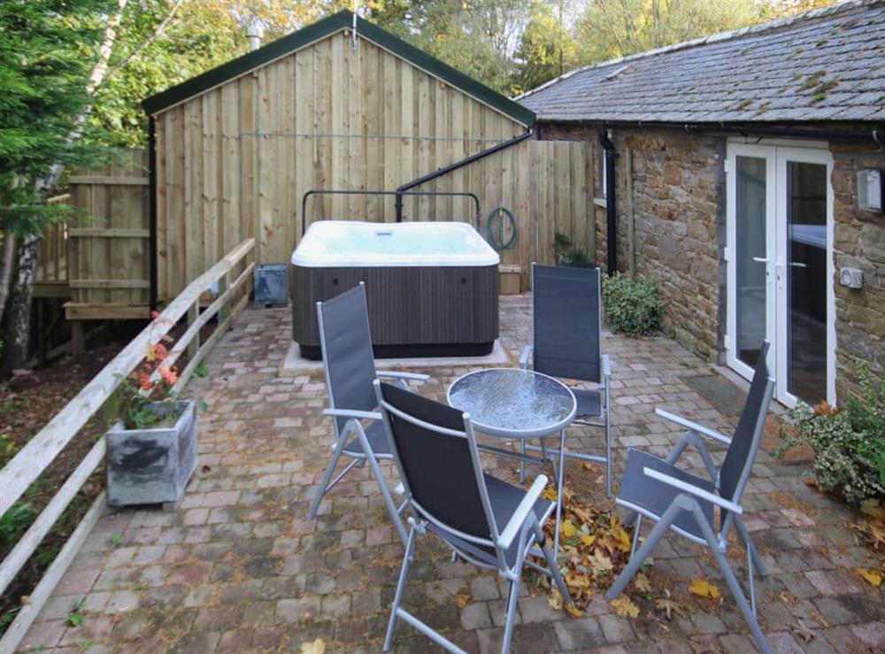 The patio makes a great place to sit out or enjoy a relaxing session in the Jaccuzi at Nuthatch Cottage in Wigton, Cumbria