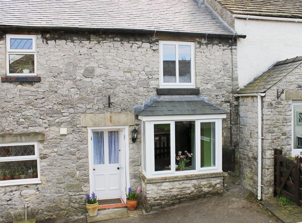 Stone-built, traditional terraced cottage at Nutmeg Cottage in Tideswell, near Buxton, Derbyshire, England