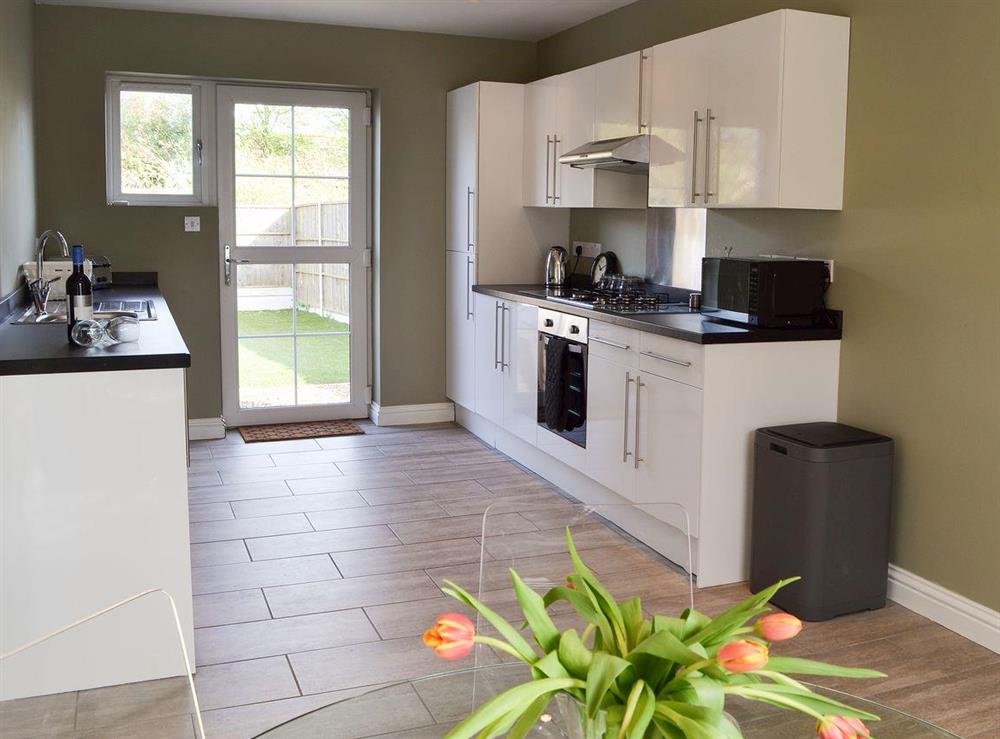 Kitchen with breakfast area at Nyetimber Cottage in Pagham, near Bognor Regis, West Sussex