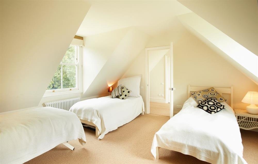 West wing large bedroom with three 3’ single beds at Oak Cliff Place, Ryde