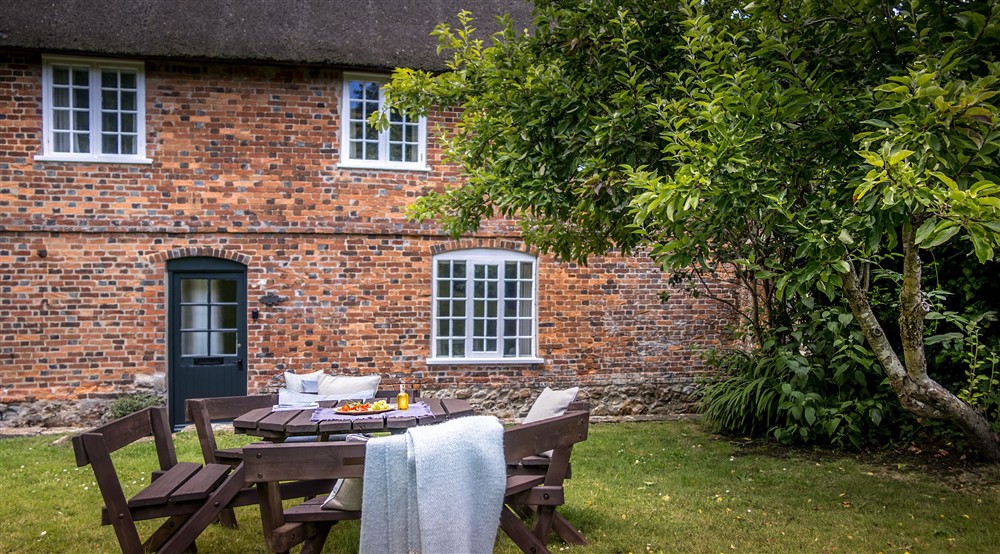 The exterior of Oak Cottage and its picnic table, Dorset at Oak Cottage in Bridport, Dorset