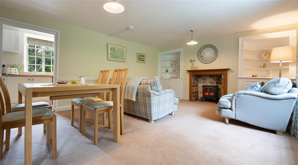 The open-plan sitting and dining room at Oak Cottage in Bridport, Dorset